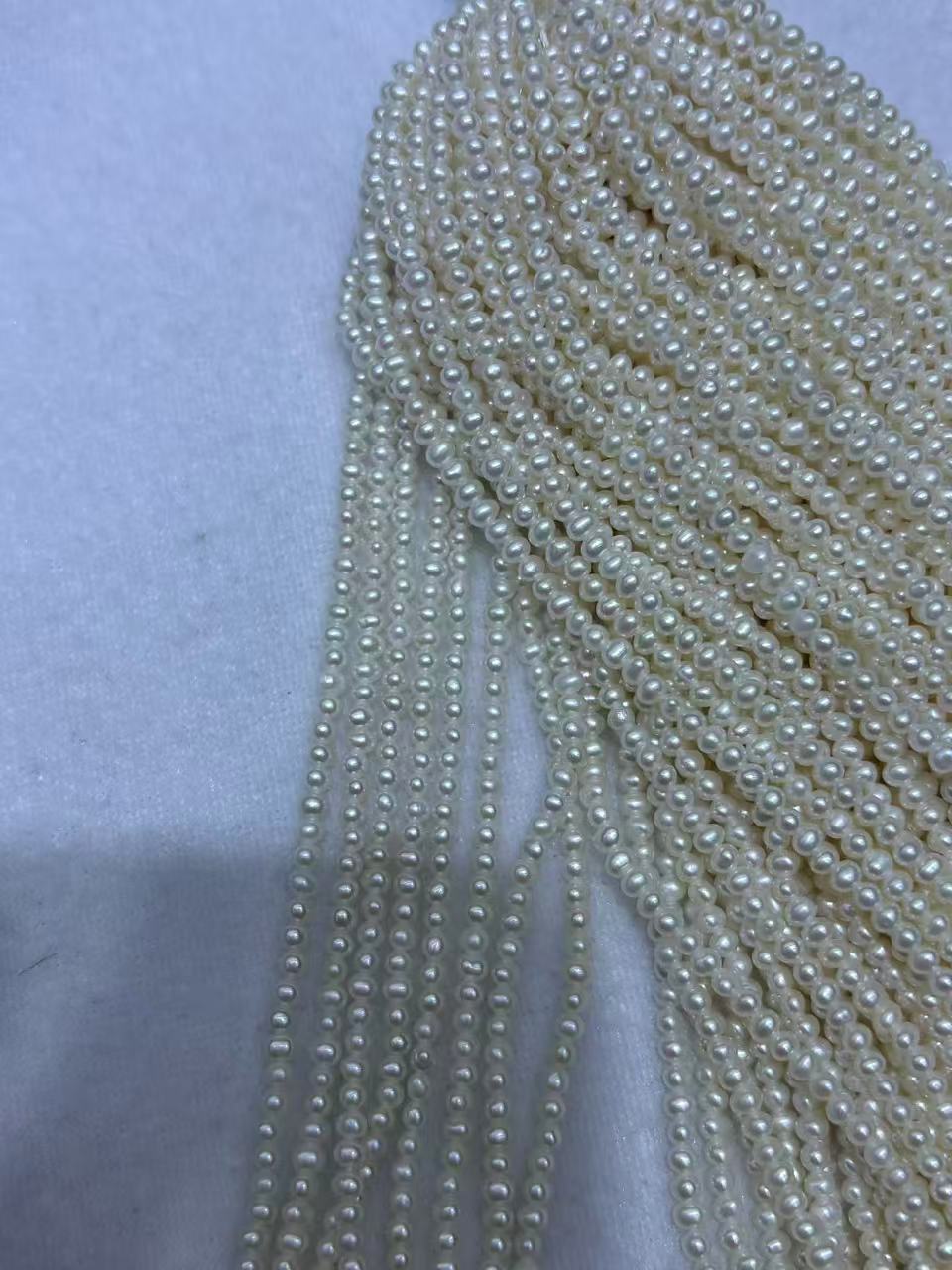 White Oval Freshwater Pearl Strand | 2–2.5mm AAA Grade | Per Strand