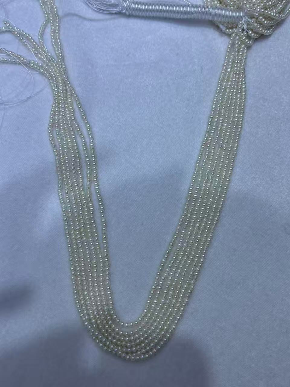 White Oval Freshwater Pearl Strand | 2–2.5mm AAA Grade | Per Strand